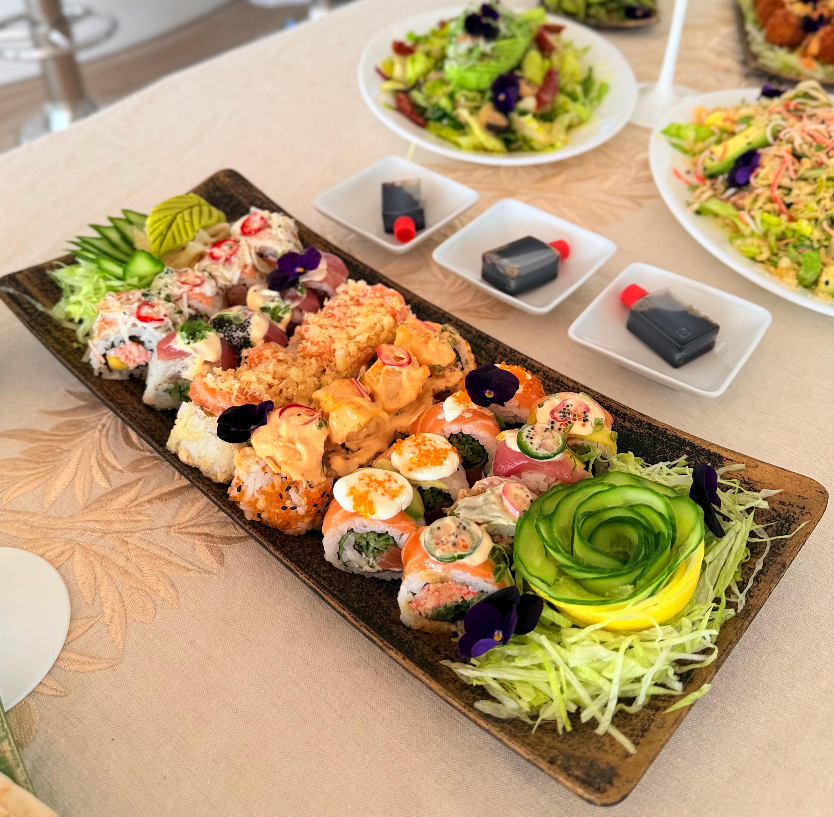 Gourmet sushi platter with fresh seafood and edible flowers for romantic yacht dinner in Dubai